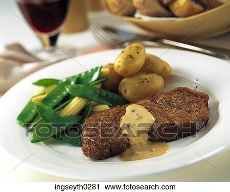 Stock Image - steak, bearnaise, mange tout, new potatoes, main course, baby corn, butter. Fotosearch