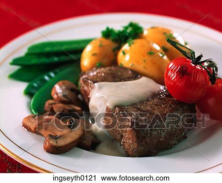 Stock Image - steak, mushrooms, potatoes, baked tomatoes, cherry tomatoes, fillet steak, fillet. Fotosearch