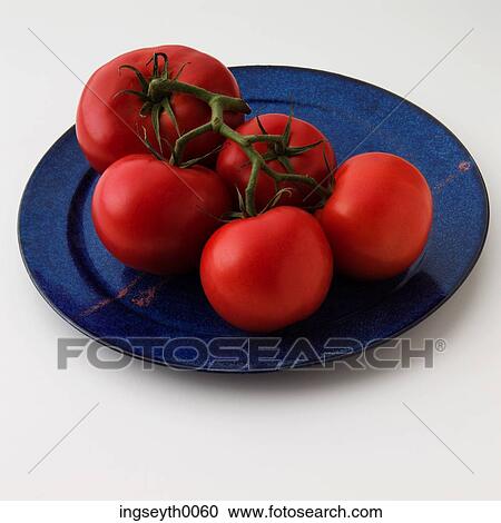 Stock Image - tomato, tomatoes, vine tomatoes, blue plate, red tomatoes, food, diet. Fotosearch
