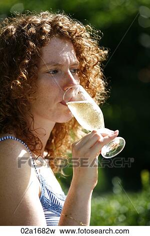 A beautiful woman drinking champagne View Large Photo Image Stock Photo - A beautiful woman drinking champagne. Fotosearch