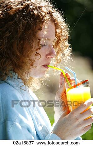 A beautiful woman drinking juice View Large Photo Image Stock Photo - A beautiful woman drinking juice. Fotosearch