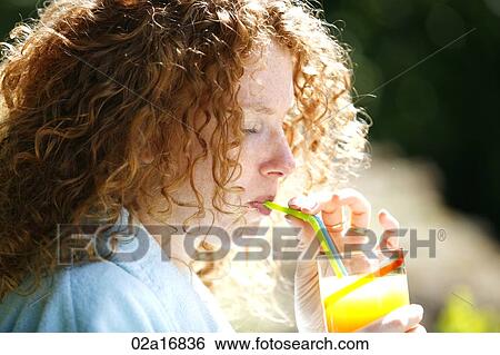 A beautiful woman drinking juice View Large Photo Image Stock Photograph - A beautiful woman drinking juice. Fotosearch