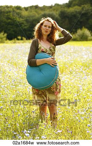 A beautiful woman in a field of flowers View Large Photo Image Stock Photo - A beautiful woman in a field of flowers. Fotosearch