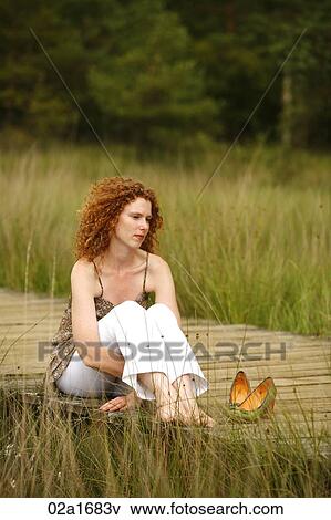 Stock Photo - A beautiful woman in the countryside. Fotosearch