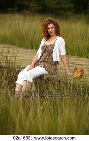 Stock Photograph - A beautiful woman in the countryside. Fotosearch