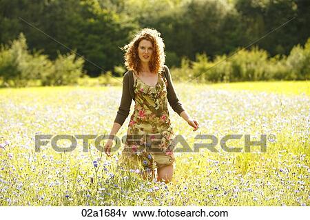 A beautiful woman picking flowers View Large Photo Image Stock Photo - A beautiful woman picking flowers. Fotosearch