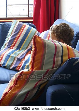 A child sitting behind a colourful striped pillow View Large Photo Image Stock Image - A child sitting behind a colourful striped pillow. Fotosearch