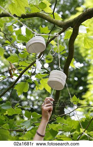 Stock Photography - A hand pulling a paper lantern. Fotosearch