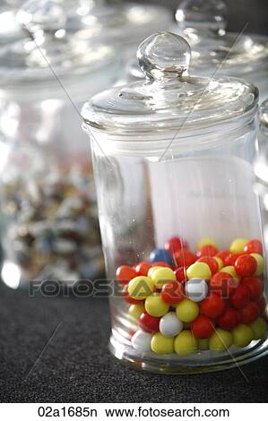 Picture - A jar of filled with multi-coloured sweets. Fotosearch