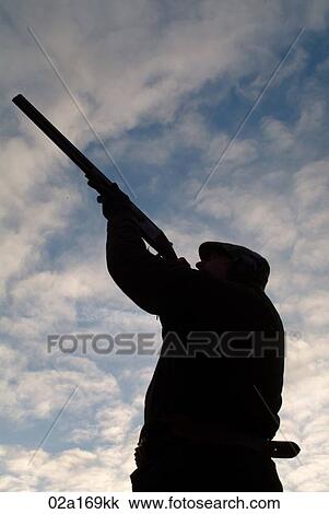 A man aiming his gun View Large Photo Image Stock Image - A man aiming his gun. Fotosearch