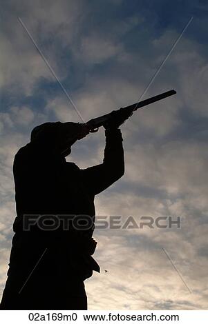 Stock Image - A man aiming his gun. Fotosearch