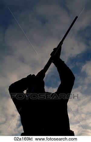 Stock Photograph - A man aiming his gun. Fotosearch