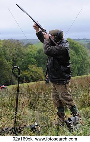 Stock Image - A man shooting a gun. Fotosearch