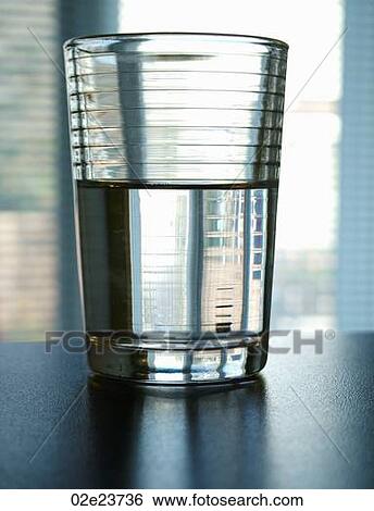 A positive half full glass of water. View Large Photo Image Stock Photograph - A positive half full glass of water.. Fotosearch