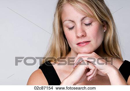 Picture - A serene blonde woman with eyes closed.. Fotosearch