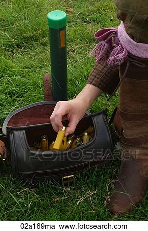 A woman holding a shotgun cartridge View Large Photo Image Stock Image - A woman holding a shotgun cartridge. Fotosearch