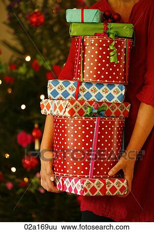 A woman holding Christmas presents View Large Photo Image Stock Photograph - A woman holding Christmas presents. Fotosearch