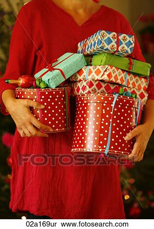 A woman holding Christmas presents View Large Photo Image Stock Photography - A woman holding Christmas presents. Fotosearch
