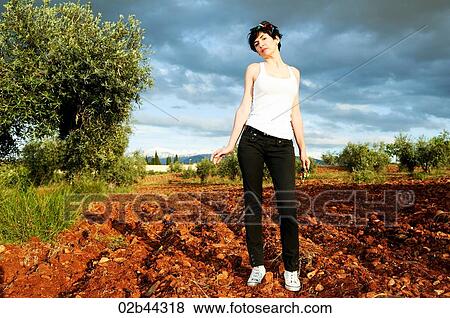 A woman in the middle of a crop fields View Large Photo Image Stock Photo - A woman in the middle of a crop fields . Fotosearch