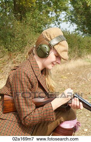 A woman loading a gun View Large Photo Image Stock Photo - A woman loading a gun. Fotosearch