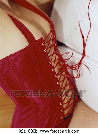 Stock Image - A woman wearing a red corset. Fotosearch