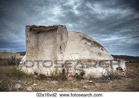 Stock Image - Abandoned building and overcast sky. Fotosearch
