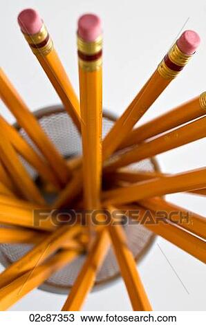 Stock Image - Aerial view of new orange HB pencils in holder, on white background.. Fotosearch