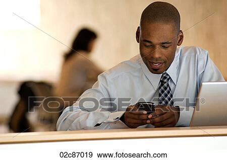 African-american businessman working on PDA. View Large Photo Image Stock Photo - African-american businessman working on PDA.. Fotosearch