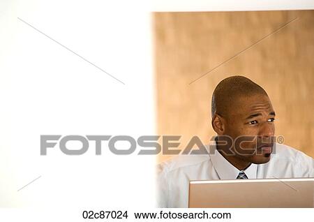 African- American businessman working on laptop. View Large Photo Image Picture - African- American businessman working on laptop.. Fotosearch