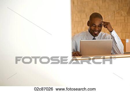 African- American businessman working on laptop. View Large Photo Image Stock Photograph - African- American businessman working on laptop.. Fotosearch