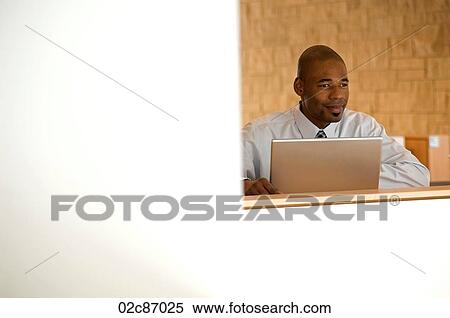 African- American businessman working on laptop. View Large Photo Image Stock Photography - African- American businessman working on laptop.. Fotosearch