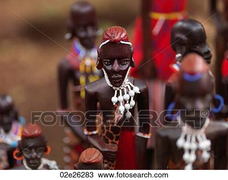 Stock Image - African carved statues. Fotosearch