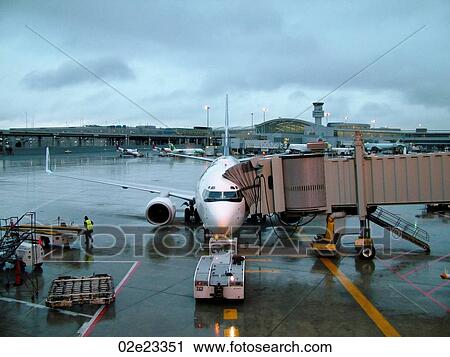 Airplane passenger jet loading at airport. View Large Photo Image Stock Image - Airplane passenger jet loading at airport.. Fotosearch
