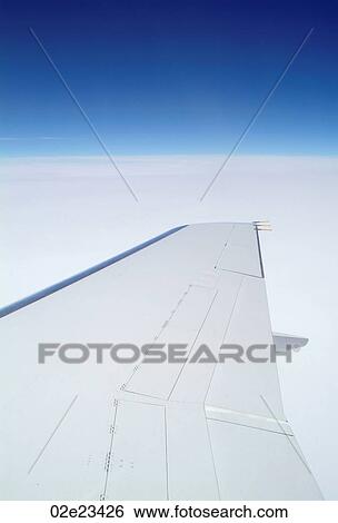 Airplane wing high in sky while flying. View Large Photo Image Stock Photograph - Airplane wing high in sky while flying.. Fotosearch