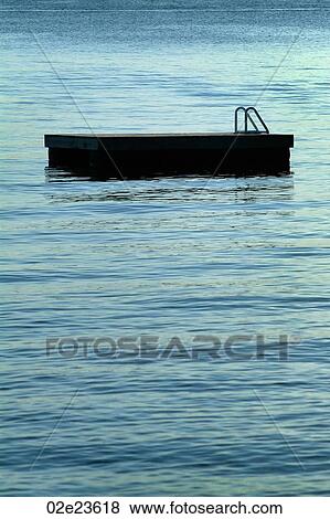 An empty floating dock on calm water. View Large Photo Image Stock Photo - An empty floating dock on calm water.. Fotosearch