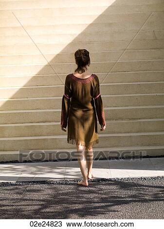 Back view of a woman walking stairs in Bali View Large Photo Image Stock Image - Back view of a woman walking stairs in Bali. Fotosearch
