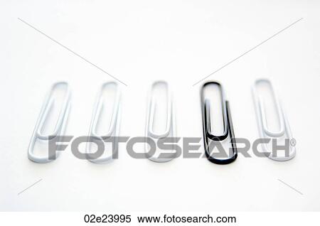 Black paper clip standing out from group of white ones. View Large Photo Image Stock Photography - Black paper clip standing out from group of white ones.. Fotosearch