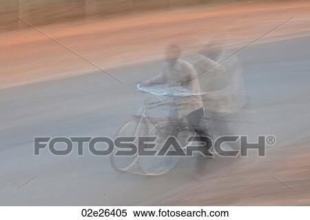 Stock Photography - Blurred picture of African man with a bicycle. Fotosearch