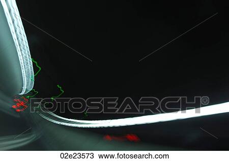 Stock Image - Blurring car lights driving though tunnel.. Fotosearch