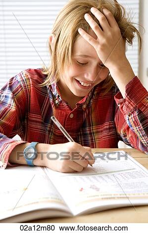 Boy writing in a book and smiling View Large Photo Image Stock Image - Boy writing in a book and smiling. Fotosearch