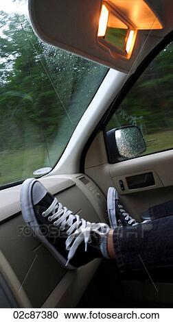 Boy's feet on dash of moving car. View Large Photo Image Stock Image - Boy's feet on dash of moving car.. Fotosearch