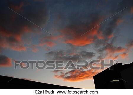 Stock Photography - Building exterior and pink night sky in Cork, Ireland. Fotosearch