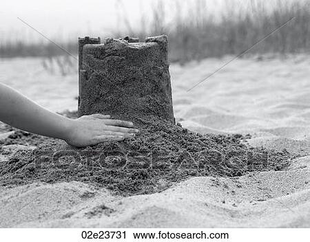 Building sand castle on beach. View Large Photo Image Stock Image - Building sand castle on beach.. Fotosearch