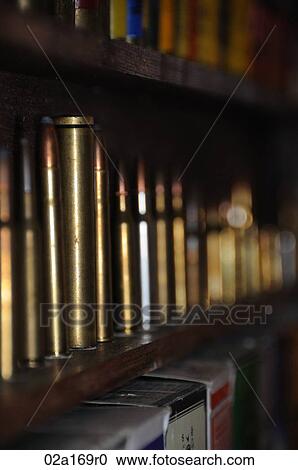 Stock Image - Bullet cartridges on a shelf. Fotosearch