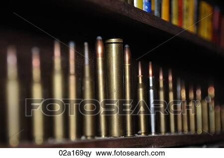 Bullet cartridges on a shelf View Large Photo Image Stock Photo - Bullet cartridges on a shelf. Fotosearch