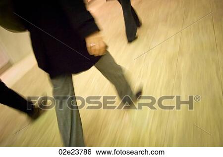 Business people walking quickly indoors. View Large Photo Image Stock Photograph - Business people walking quickly indoors.. Fotosearch