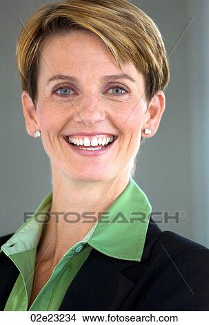 Picture - Business woman smiling at camera.. Fotosearch