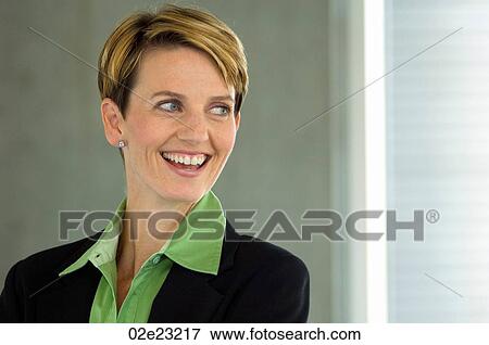 Stock Photo - Business woman, smiling off camera.. Fotosearch