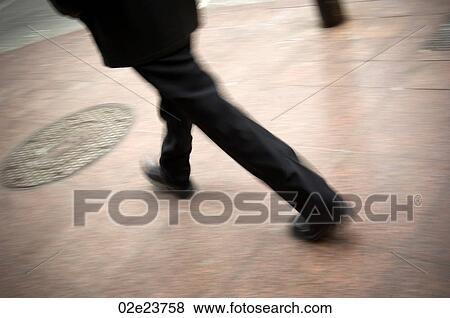 Businessman walking fast downtown. View Large Photo Image Stock Photo - Businessman walking fast downtown.. Fotosearch