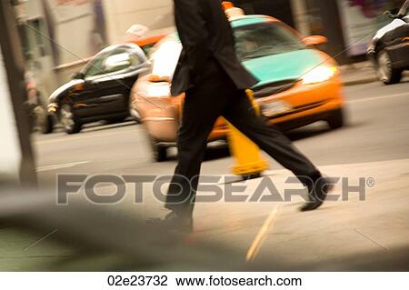 Stock Image - Businessman walking in downtown Toronto.. Fotosearch